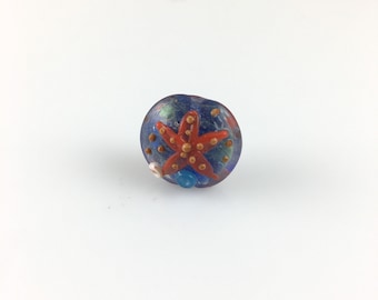 One Flat round Lampwork glass bead, orange starfish