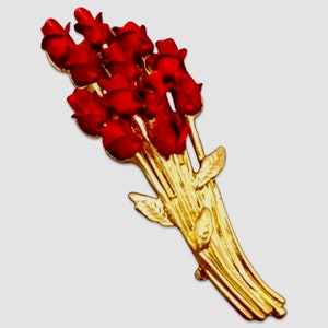 May include: A gold-toned brooch featuring a bouquet of red roses. The roses are clustered together and have a realistic appearance. The stems are gold and have small green leaves.