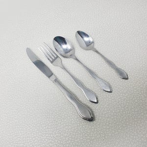 May include: A handmade wooden serving tray with a natural finish. The tray has a rectangular shape with rounded corners and two carved handles. The wood grain is visible, adding to its rustic charm. Dimensions are approx. 40 cm long and 25 cm wide.