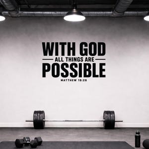 May include: A black wall decal featuring the text "WITH GOD ALL THINGS ARE POSSIBLE" in a bold, sans-serif font, with the reference "MATTHEW 19:26" underneath. The decal is applied to a light grey wall above a barbell with black weight plates.