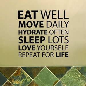 May include: A motivational quote on a beige wall with a tiled floor. The quote reads: "Eat well, move daily, hydrate often, sleep lots, love yourself, repeat for life."