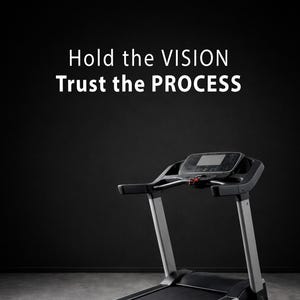 May include: A treadmill with a black running surface and a digital display. The frame is silver and black. The text "Hold the VISION, Trust the PROCESS" is in white above the treadmill against a black background.