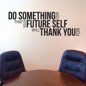 May include: A motivational quote on a white wall in a room with a wooden table and two black leather chairs. The quote reads "Do something today that your future self will thank you for."