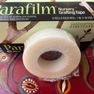 May include: A roll of clear Parafilm Nursery Grafting Tape. The tape is waterproof and stretchable. The tape is 1 inch wide and 30 yards long. The tape is self-sealing and is ideal for grafting and budding plants, flowers, trees, and shrubs.