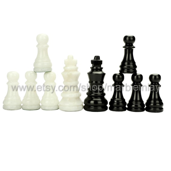 Premium Photo  Three pieces on a dark chessboard