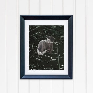 May include: A black and white photo of a person studying a star chart. The chart shows the constellations of Leo Minor, Cancer, Lynx, and Ursa Major. The person is wearing a light-colored shirt and is looking down at the chart.