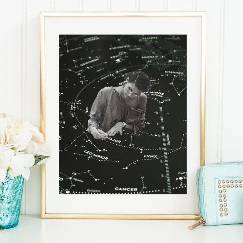 May include: A black and white photo of a person wearing glasses and a light brown shirt, drawing on a black background with white constellations and the names of constellations, including Leo Minor, Lynx, Cancer, and Ursa Minor.