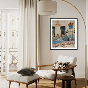 May include: A framed print of a surrealist collage featuring women in blue dresses standing on a beach with a miniature city in the background.