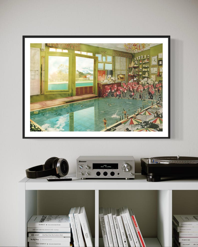 May include: A framed collage art print featuring a surreal indoor swimming pool scene with a view of a tropical landscape through a large window. The pool is filled with water and surrounded by lush greenery and flowers. The scene is reminiscent of a dreamlike escape.