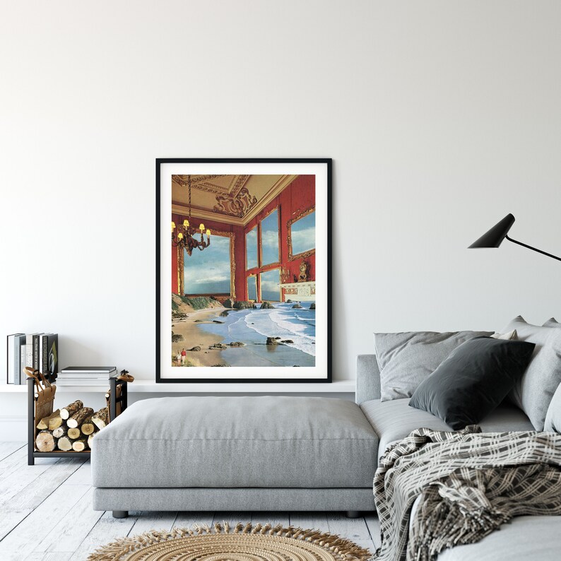 May include: A framed print of a surrealist artwork depicting a red room with multiple windows that open to a beach scene with crashing waves. The room is decorated with a chandelier and a fireplace.