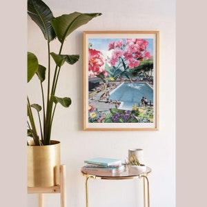 May include: A framed print of a collage featuring a swimming pool with people in it, surrounded by pink flowers and green foliage.