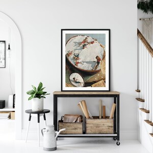 May include: A framed collage of a vintage photograph of children playing in a large bowl of whipped cream. The image is in a black frame and is hanging on a white wall.