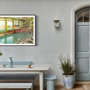 May include: A framed vintage illustration of a swimming pool with people in bathing suits. The pool is surrounded by a green tiled floor and the walls are painted a pale green. The windows are open and there is a view of a mountain range in the distance.