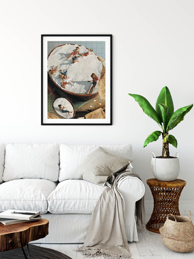May include: A collage of a group of children playing in a large, white, fluffy cloud. The children are wearing colorful clothing and are having fun. The collage is framed in a black frame and is hanging on a white wall.
