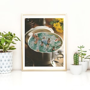 May include: A white ceramic serving bowl filled with blue water and miniature people swimming. The bowl is decorated with a gold rim and handle.