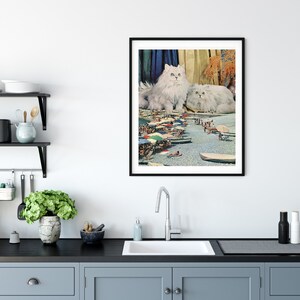 May include: A framed collage featuring two white Persian cats sitting on a beach scene with colorful umbrellas and people in the background.