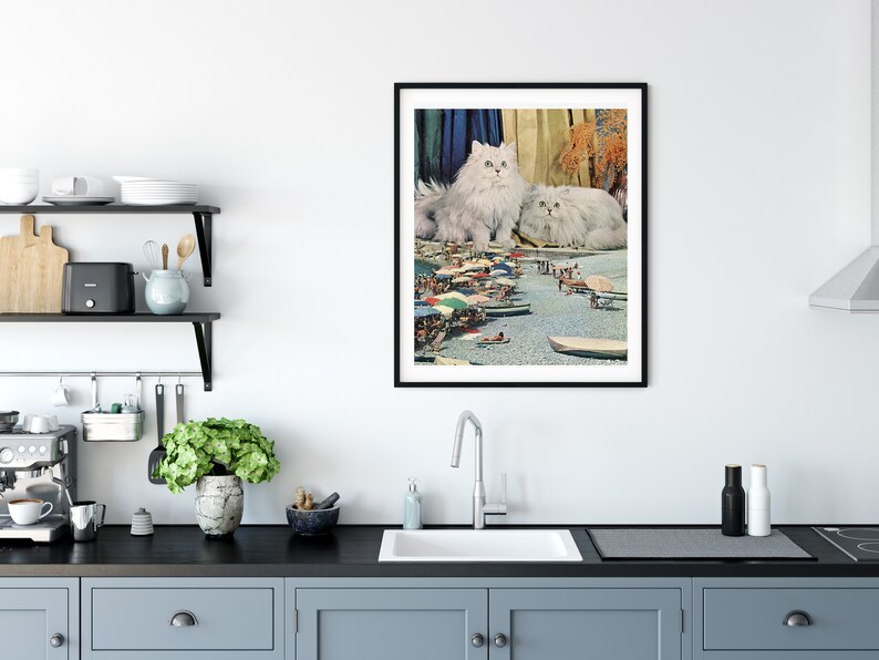 May include: A framed collage featuring two white Persian cats sitting on a beach scene with colorful umbrellas and people in the background.