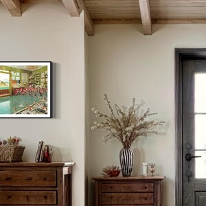 May include: A framed vintage postcard depicting a swimming pool with people in bathing suits. The pool is surrounded by a green tiled wall and there are windows on the side of the pool.