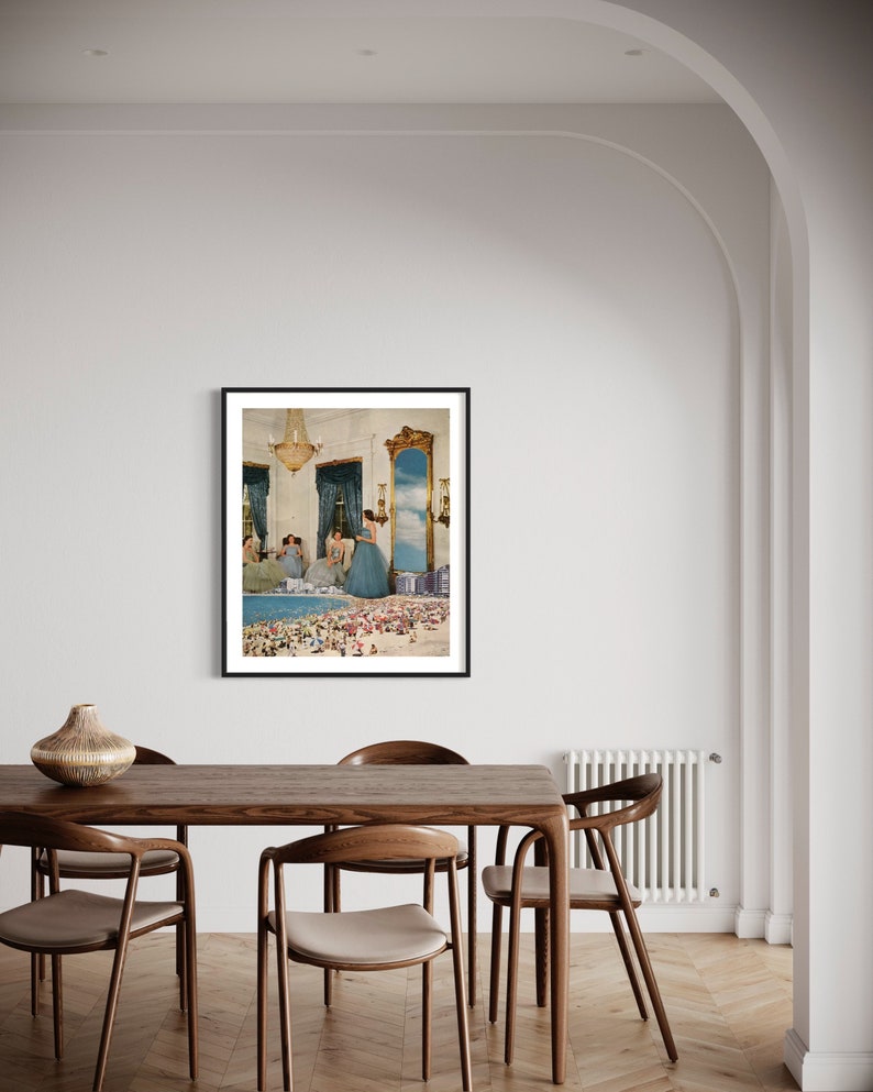 May include: A framed collage artwork depicting a room with a chandelier and a mirror reflecting a beach scene with people. The women in the room are wearing blue dresses.
