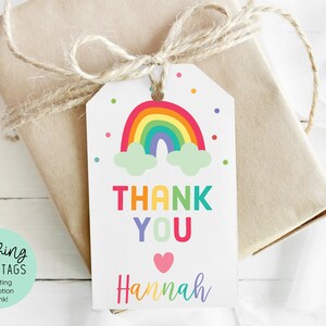 May include: Rainbow-themed thank you tag with the text "Thank You" in rainbow colors and the name "Hannah" in purple. The tag features a colorful rainbow with clouds and confetti.