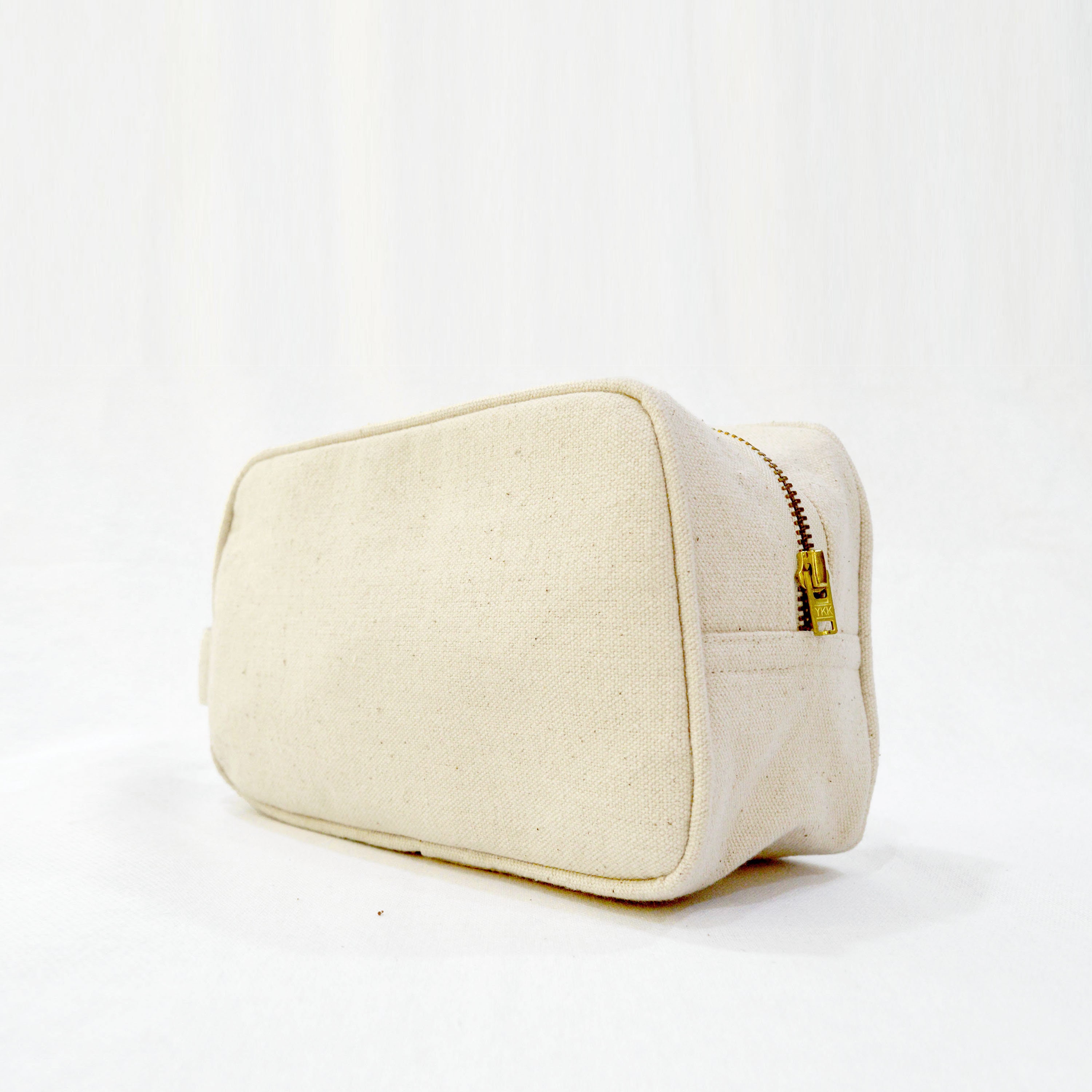 Toiletry bag, off white, zip closure.