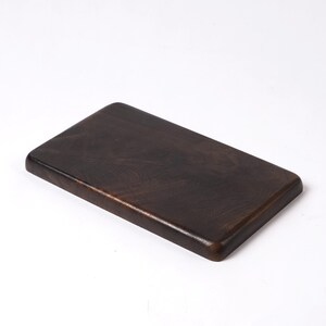 May include: A dark brown rectangular wooden serving tray with rounded edges.