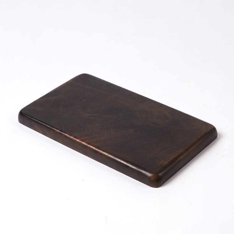 May include: A dark brown rectangular wooden serving tray with rounded edges.