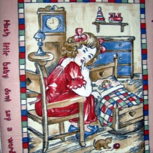 May include: A pink and cream colored blanket with a vintage illustration of a girl in a red dress sitting in a rocking chair. The girl is holding her finger to her lips and looking at a doll in a crib. The text "Hush little baby don't say a word" is printed on the left side of the blanket.