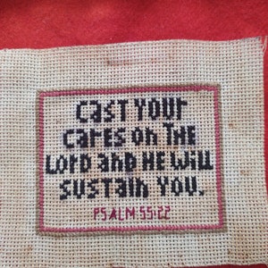 May include: White cross-stitch embroidery with the text "Cast your cares on the Lord and he will sustain you. Psalm 55:22"