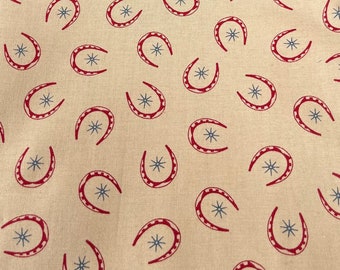 Rawhide by Moda Featuring Red Horseshoes and Blue Stars on Brown - 100% cotton Dressmaking Fabric - 42" x 94"