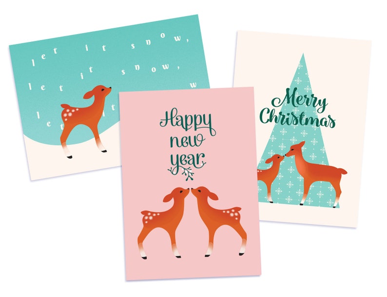 May include: Three Christmas cards featuring a deer design. The first card is blue with the text "Let it snow, let it snow, let it snow". The second card is pink with the text "Happy New Year". The third card is cream with a blue and white patterned Christmas tree and the text "Merry Christmas".