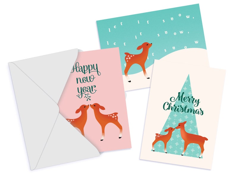 May include: Set of three Christmas cards featuring a deer design. The first card is pink with two deer kissing. The second card is green with a single deer and the text "let it snow". The third card is cream with a Christmas tree and two deer kissing. The text "Merry Christmas" is on the card.