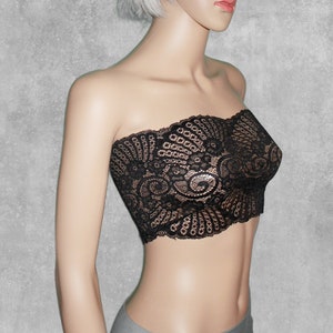 May include: A black lace strapless top with a floral pattern. The top is made of delicate lace and has a fitted silhouette.