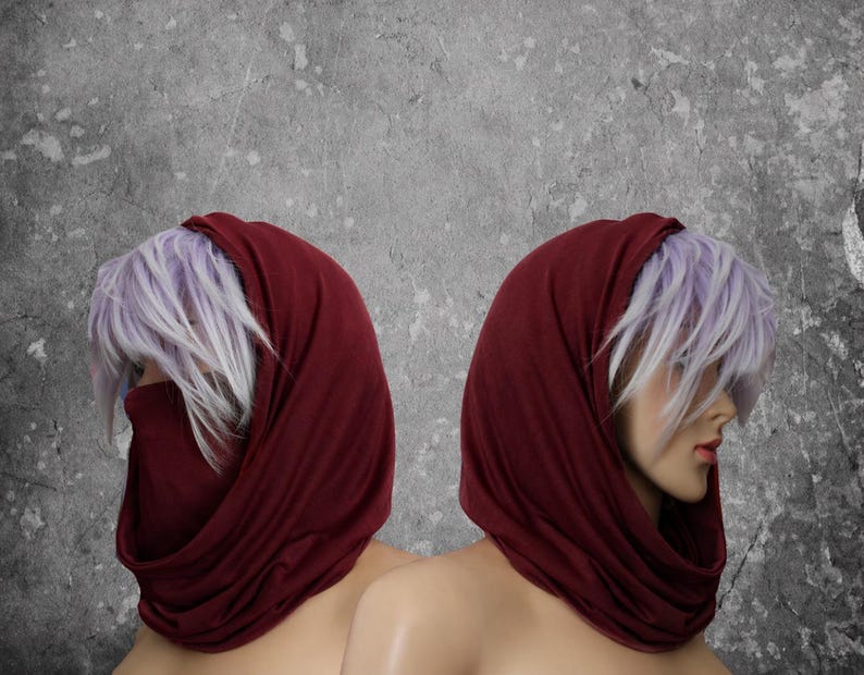 Peut inclure: Deux mannequins avec des couvre-chefs bordeaux et des cheveux violets clairs et blancs. Les couvre-chefs sont drap&eacute;s autour du cou et du visage. Le fond est gris mouchet&eacute;.