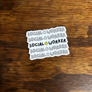 May include: White sticker with the text "SOCIAL WORKER" repeated five times, each line with a smiley face.