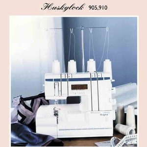 May include: White Husqvarna Viking Husklylock 905,910 sewing machine with four spools of thread and a piece of fabric. The machine has a blue and white display and a silver foot pedal.
