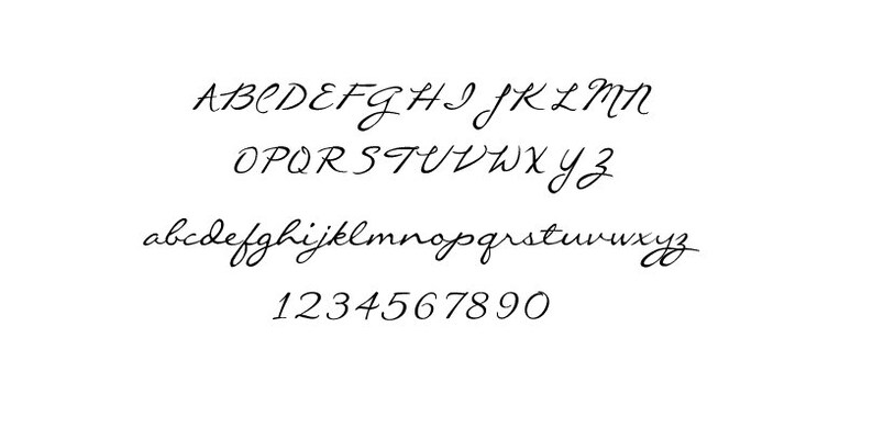 May include: A handwritten font alphabet in black ink on a white background. The alphabet includes uppercase and lowercase letters and numbers 0-9.