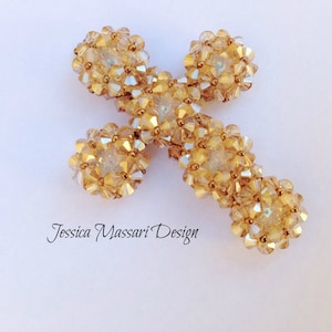 May include: A gold cross made of small, faceted beads. The cross is a religious symbol and is often used in jewelry and home decor.
