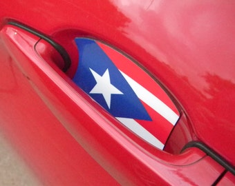 May include: A red car door with a Puerto Rican flag sticker on the door handle.