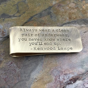 May include: A brass money clip with the inscription "Always wear a clean pair of underwear, you never know where you'll end up. - Kenwood Lampe"