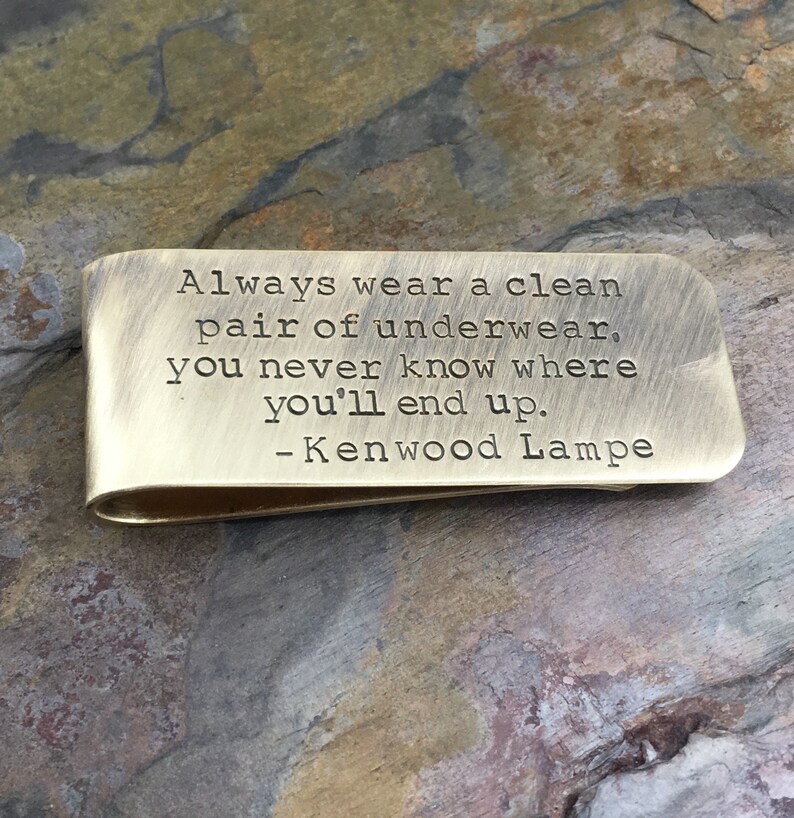 May include: A brass money clip with the inscription "Always wear a clean pair of underwear, you never know where you'll end up. - Kenwood Lampe"