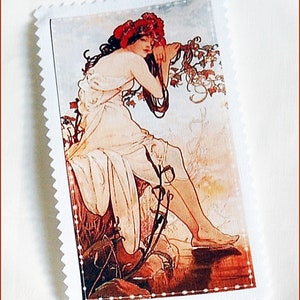 May include: A vintage-style illustration of a woman with red hair and a white dress, sitting on a rock with a floral background. The image is framed with a white border.