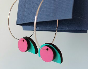 Layered hoop earrings with green and pink geometric shapes