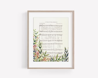 May include: A framed print of a vintage hymn sheet music with the lyrics and sheet music for "O Come, O Come, Emmanuel". The hymn sheet is surrounded by a watercolor illustration of green leaves and red berries.