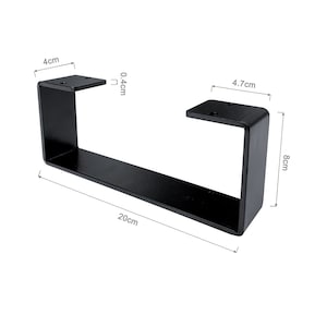 Peut inclure: Un pied de table en m&eacute;tal noir en forme de U rectangulaire. La jambe mesure 20 cm de long, 8 cm de haut et 4,7 cm de large. La plaque sup&eacute;rieure mesure 4 cm de large et 0,4 cm d'&eacute;paisseur. Le pied a des trous pr&eacute;-perc&eacute;s pour le montage.
