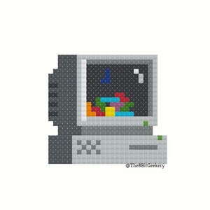 May include: Pixel art illustration of a vintage computer with a gray and black monitor and a gray keyboard. The monitor screen displays a colorful pixelated game.