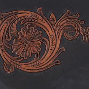 May include: A brown leather design with a floral pattern, featuring a large flower in the centre and intricate swirls and leaves.
