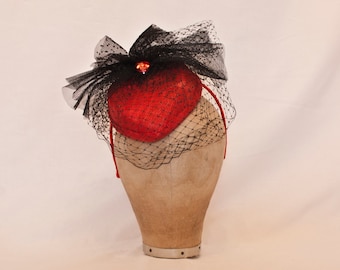 Handmade red heart shaped ladies hat with black tulle bow and veiling. A perfect addition to your special occasion outfit