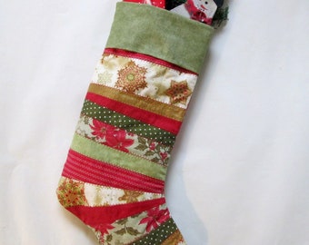 Large Christmas stocking quilted in prints of traditional Christmas colors of red, green, cream and metallic gold. 19” high, Stocking Only