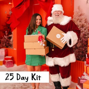 May include: A 25 Day Kit consisting of three stacked brown cardboard boxes held by a person in a green houndstooth blazer, alongside a figure dressed as Santa Claus holding a similar brown box. A small elf doll sits on the top box.